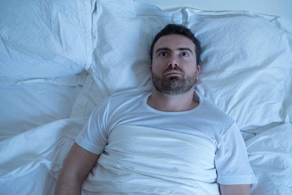 Man lying awake with insomnia